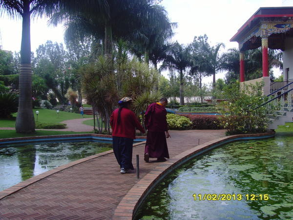 a tibetan couple in the gardens of the monastry