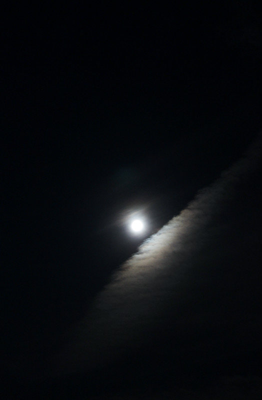 Moon reflecting on vapor trail