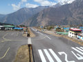 Lukla airport runway - Brick wall one end and drop of death at the other