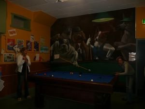 Annique and Caroline playing pool in front of one of the hostel murals