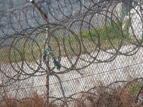 Razor Wire with escapee attempt clothing remaining as a warning to others