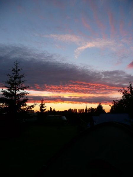 Spectacular sunset over the campsite as we hurry to put the tents up at the end of an emotional day.