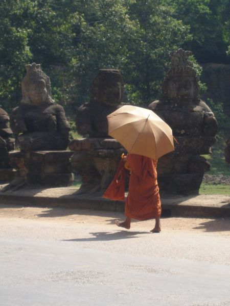 monk walking to Angkor Wat