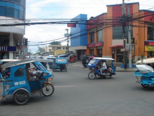 Puerto street scene. Not many private cars here, lots of tricycles. 