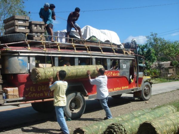 Loading our jeepney along the way. This was a roll of woven bamboo used for the walls of the nippa huts.