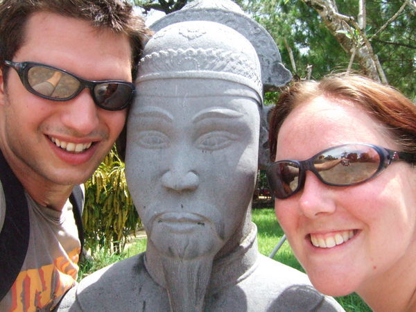Mark and Chrissie with a stone warrior at Minh Mang's tomb
