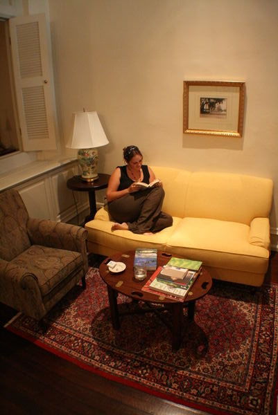Chrissie reading in the lounge of our Suite at Raffles