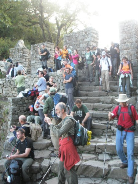 tourists at the sungate overlooking machupichu