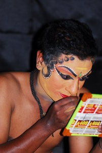 Kathakali performer making up