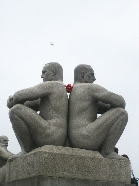 (in between) two naked granite men statue