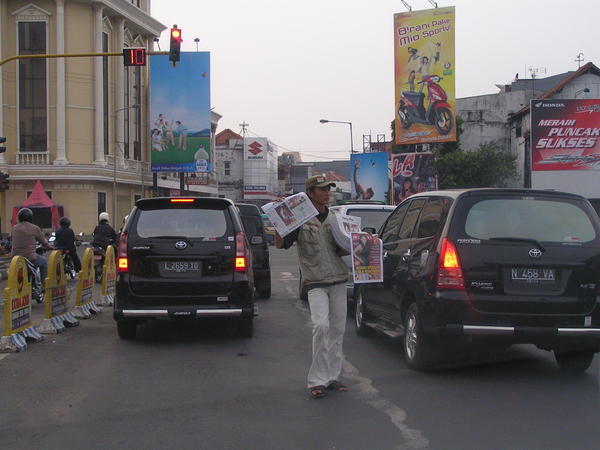 typical dude selling 'koran' ( newspaper ) on street