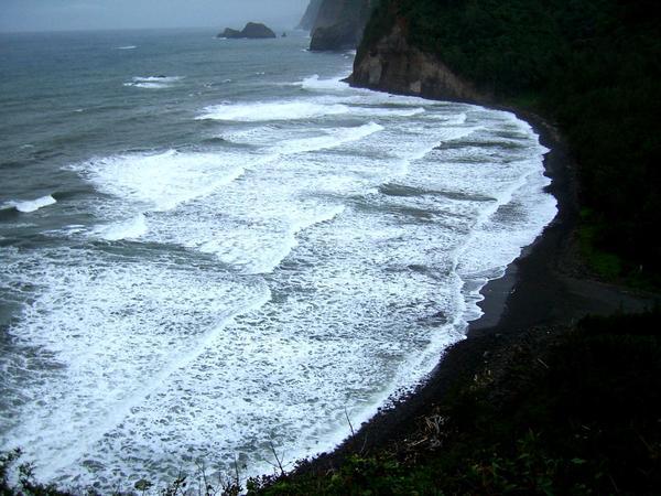 The blacksand beach at the bottom of the valley