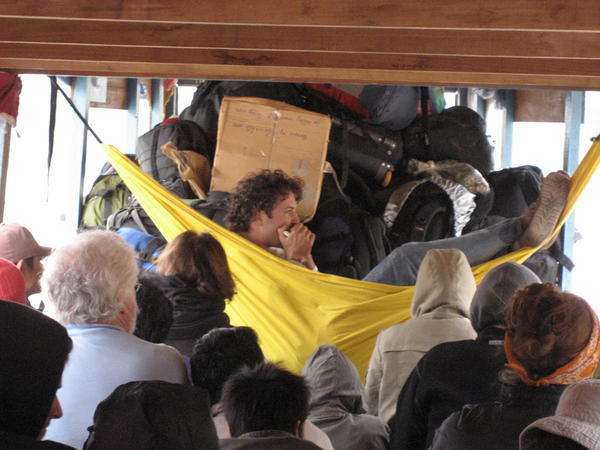 playing harmonica in the best seat in the boat (I think he's Israeli)