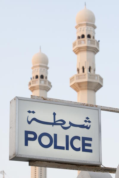 police sign and mosque towers
