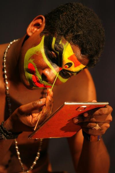 Kathakali dancer applying makeup