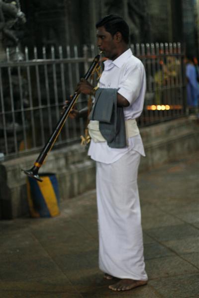 Temple musician playing an oboeish instrument