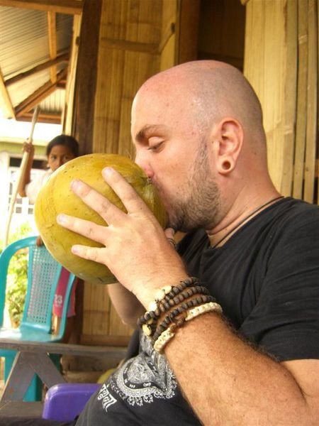 Jeff drinking from a coconut