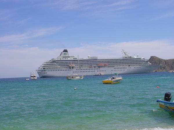 A smaller cruise ship harbored in the Bay of Cabo San Lucas