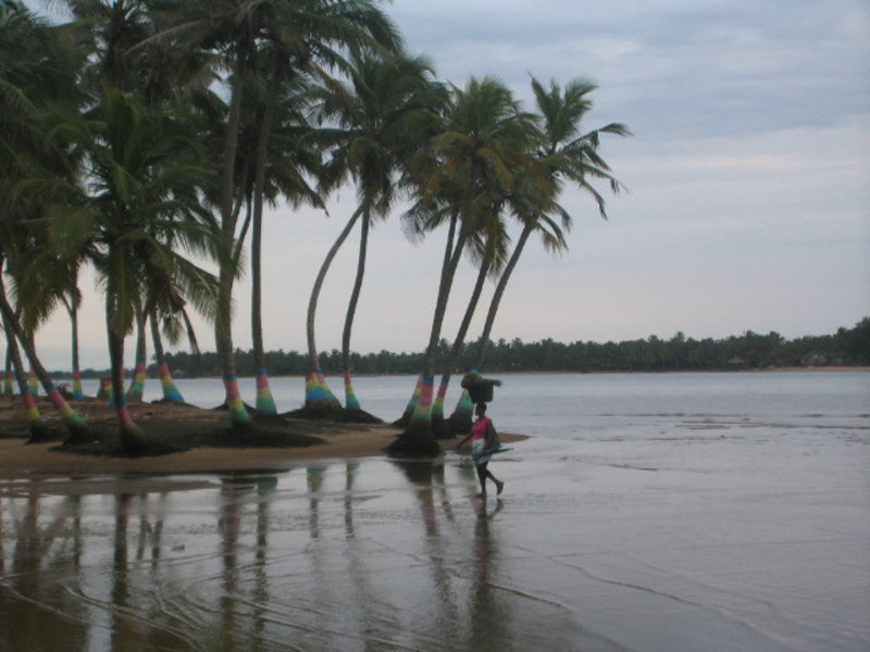 Woman carrying load from boat to shore