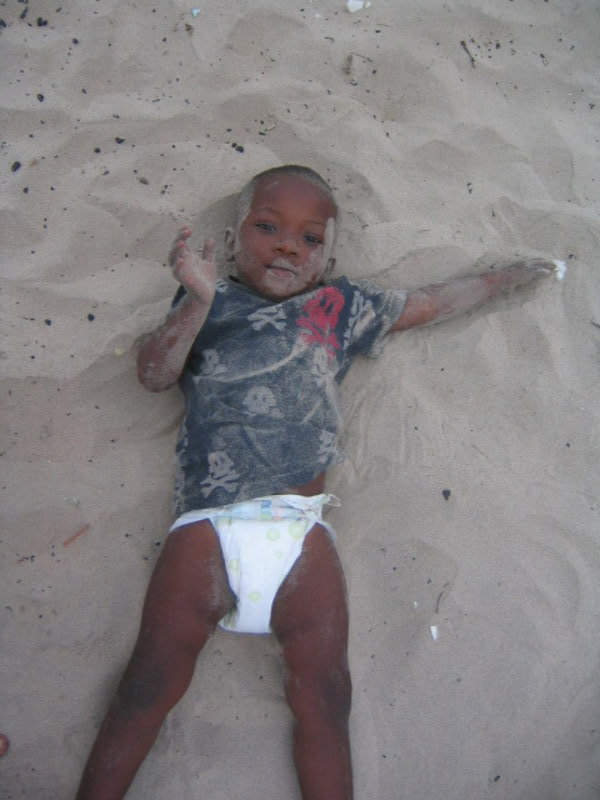Emmanuel rolling in the sand