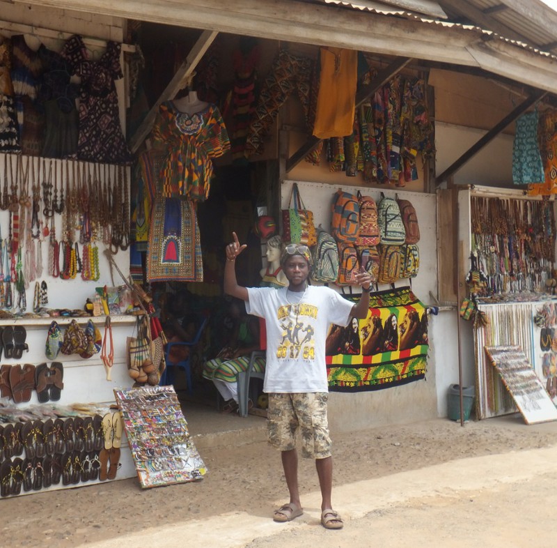 Another view of the art market with one of the vendors posing