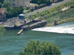 River Doubs lock with adjacent barrage in flood.