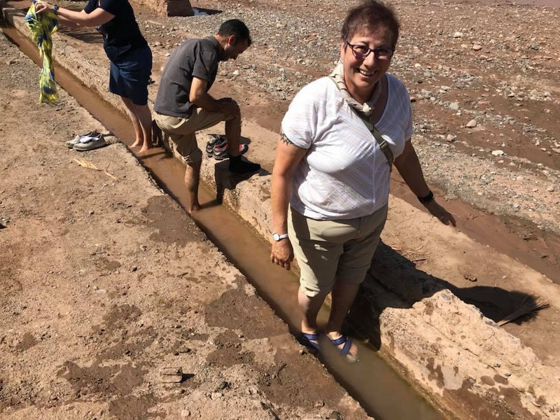 Susan washing her feet in irrigation canal