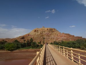 Heading over the bridge to walk to the fortified granary of AIt Benhaddou