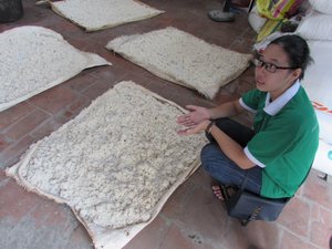 Trang explaining the rice wine making process