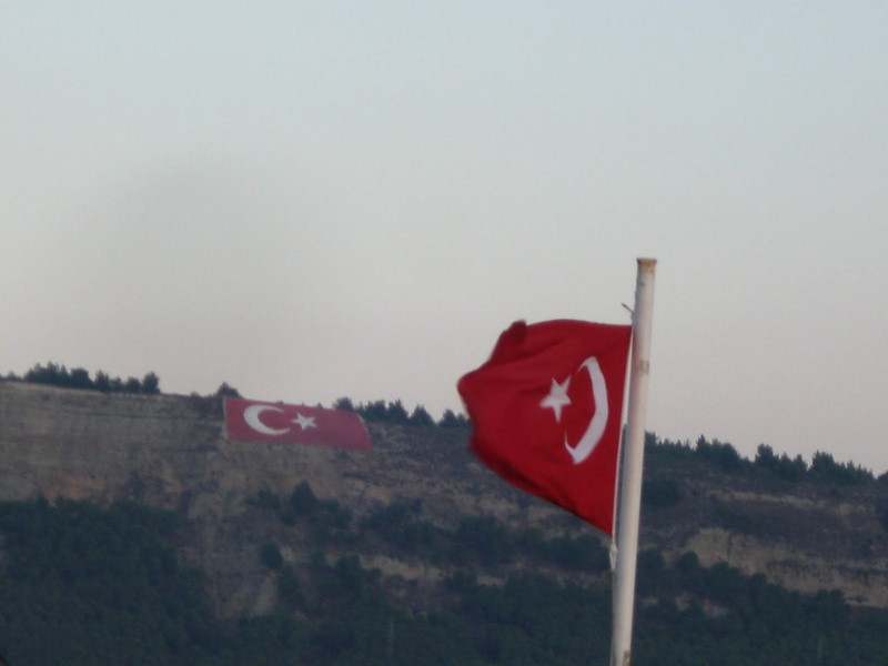 Turkish flag on the ferry and Turkish flag on the hillside