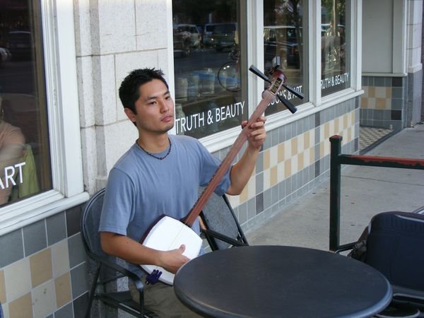 Playing a Japaneese "banjo" 