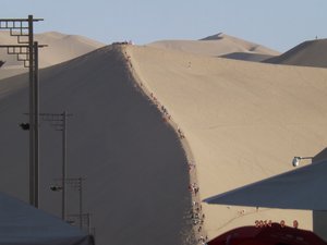 Dunhuang - Who on earth would want to climb in this heat ??  Apparently all these people 