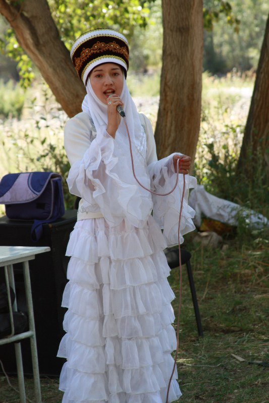 Local Kyrgyz lass singing traditional songs