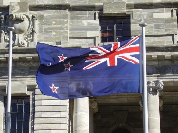 New Zealand Flag in fron of one of the Parliment buildings.