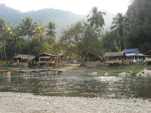 Small Laos river village we passed on way to caves