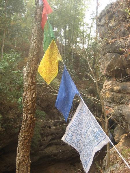 Prayer flags near a waterfall we drove our MOTORBIKES to
