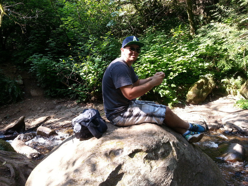 Pat texting on top of the waterfall.