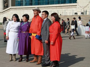 Attending a wedding in their national costumes
