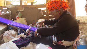 Elderley woman weaving in village