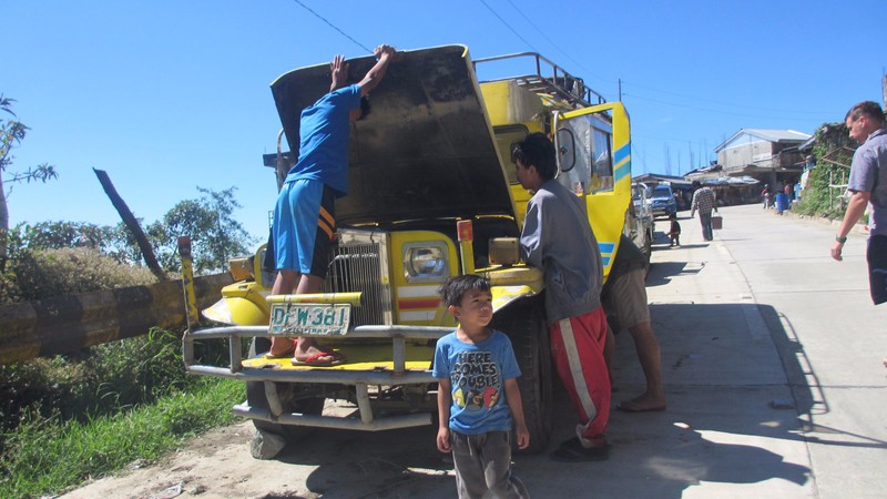 Young boys trying to fix jeepney