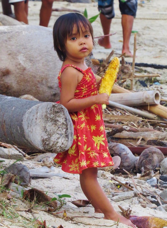 Young girl enjoying some corn