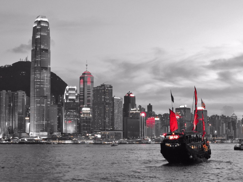 A junk boat sailing through Kowloon peninsular