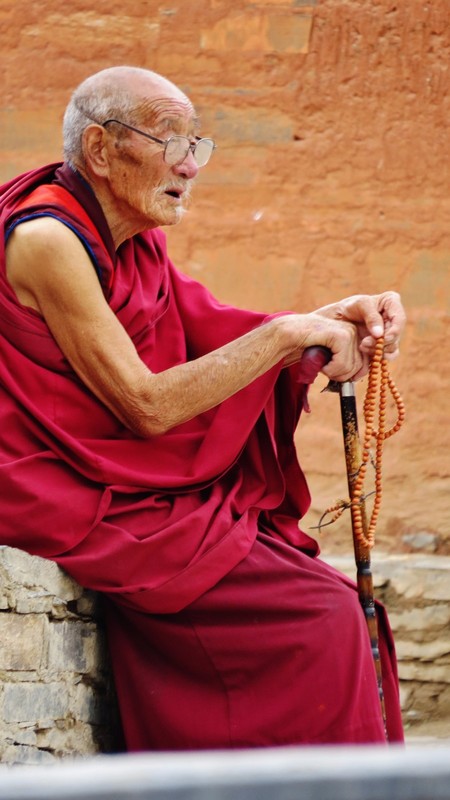 Buddhist monk with his beads