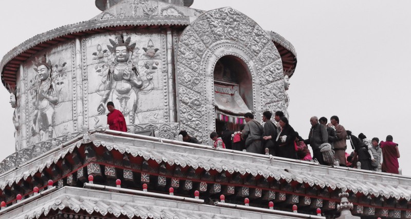 Locals at the top of a stupa paying respects to buddha