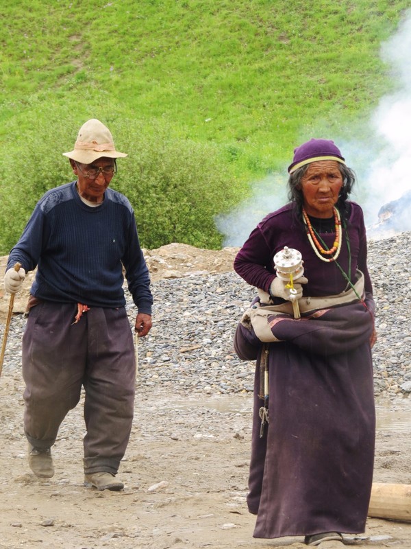 2 elderly pilgrims on their way around the monastery 