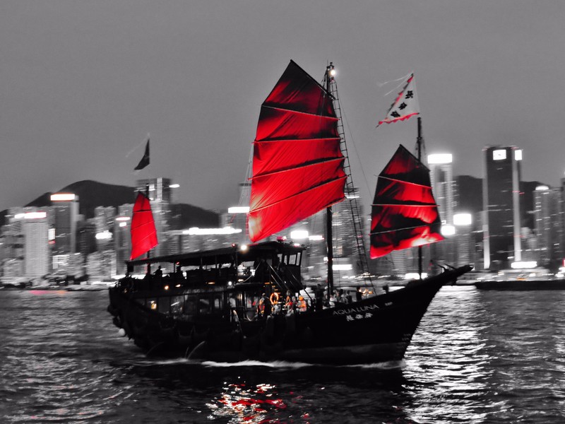 Junk boat sailing through Kowloon Peninsular