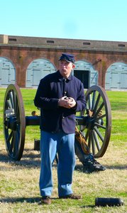 re-enactor in Union uniform explains cannon firing demonstratiion