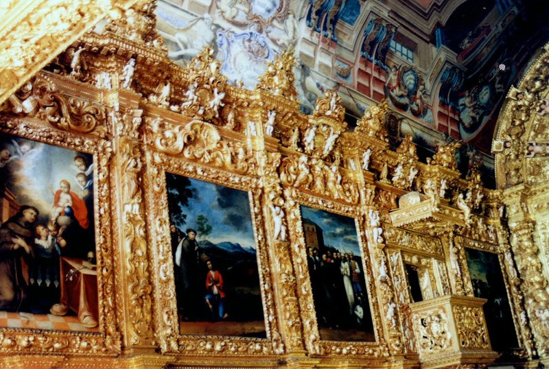 Gilded paintings of his life line the walls