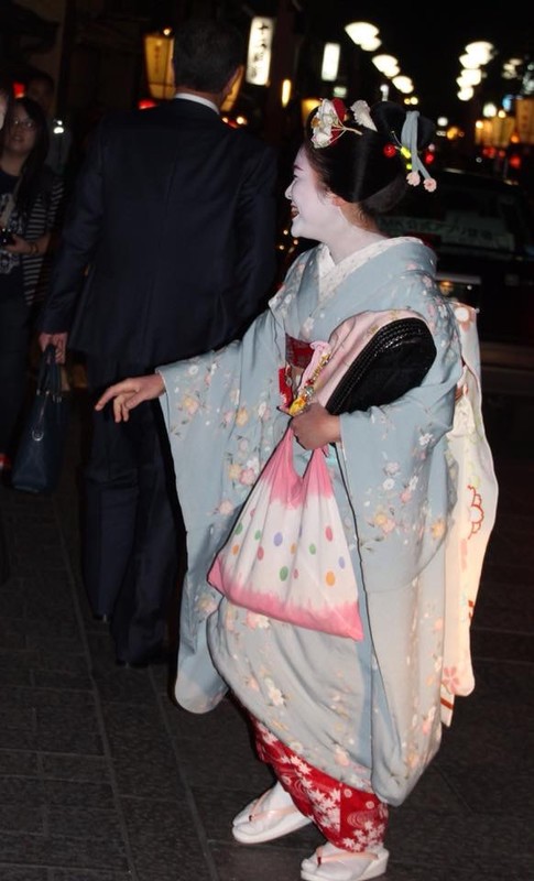 Maiko farewells a client outside a Gion tea house.