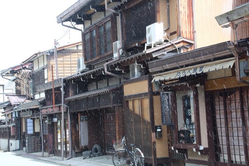 Snow falls in front of the Edo-era buildings of Takayama 